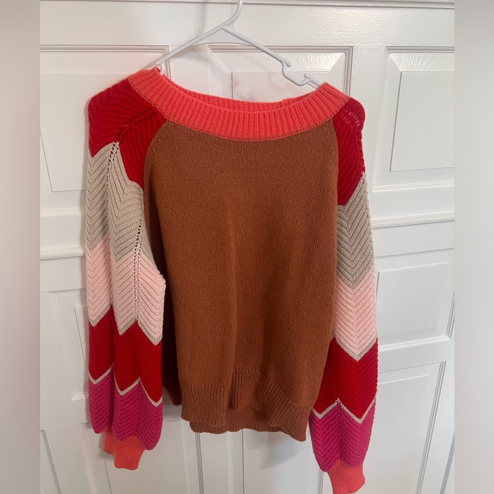 Beautiful fall colored sweater with chevron multi colored sleeves.